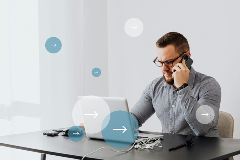 Professional man multitasks with laptop and smartphone in home office environment.